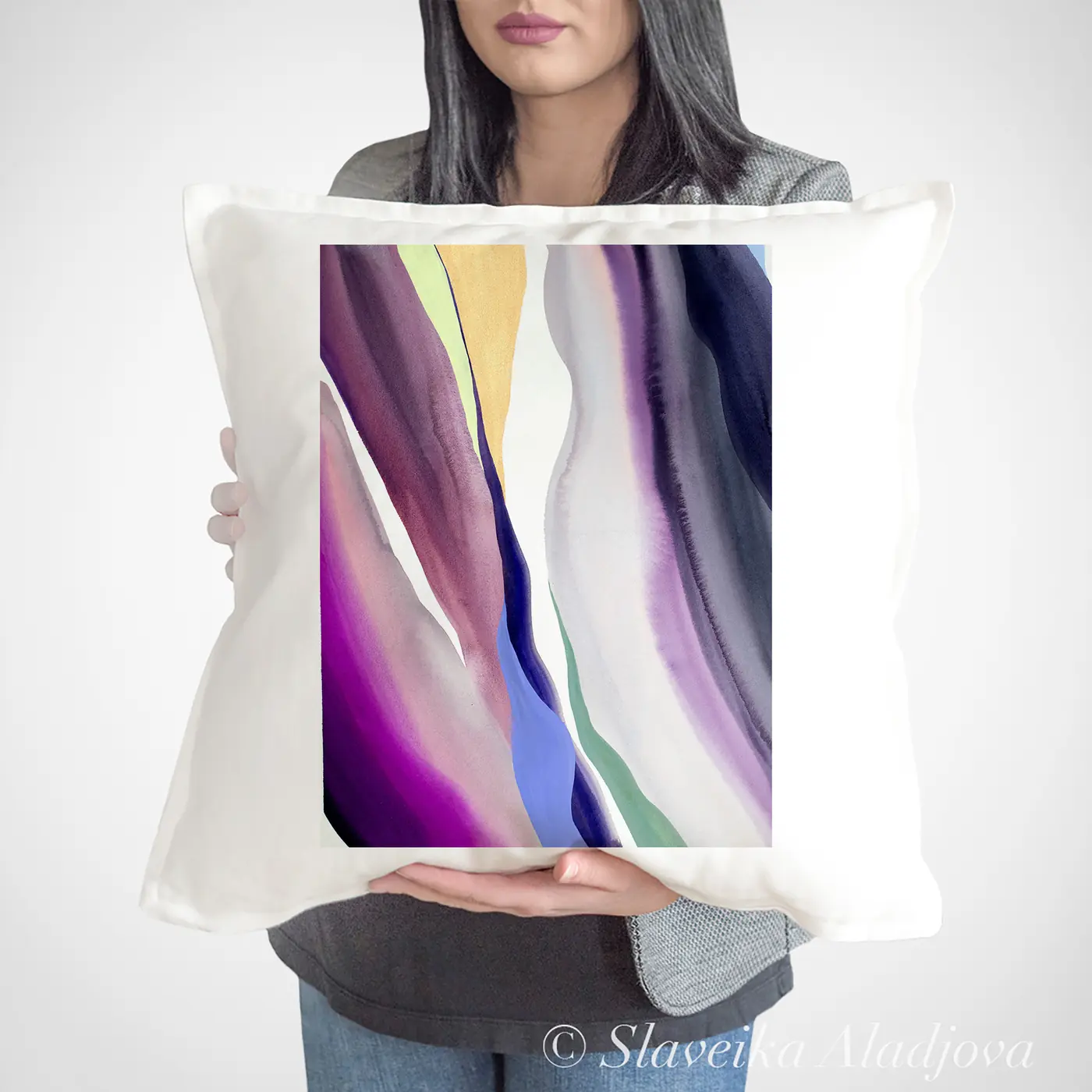 Cushion with a watercolour abstract in purple and green print
