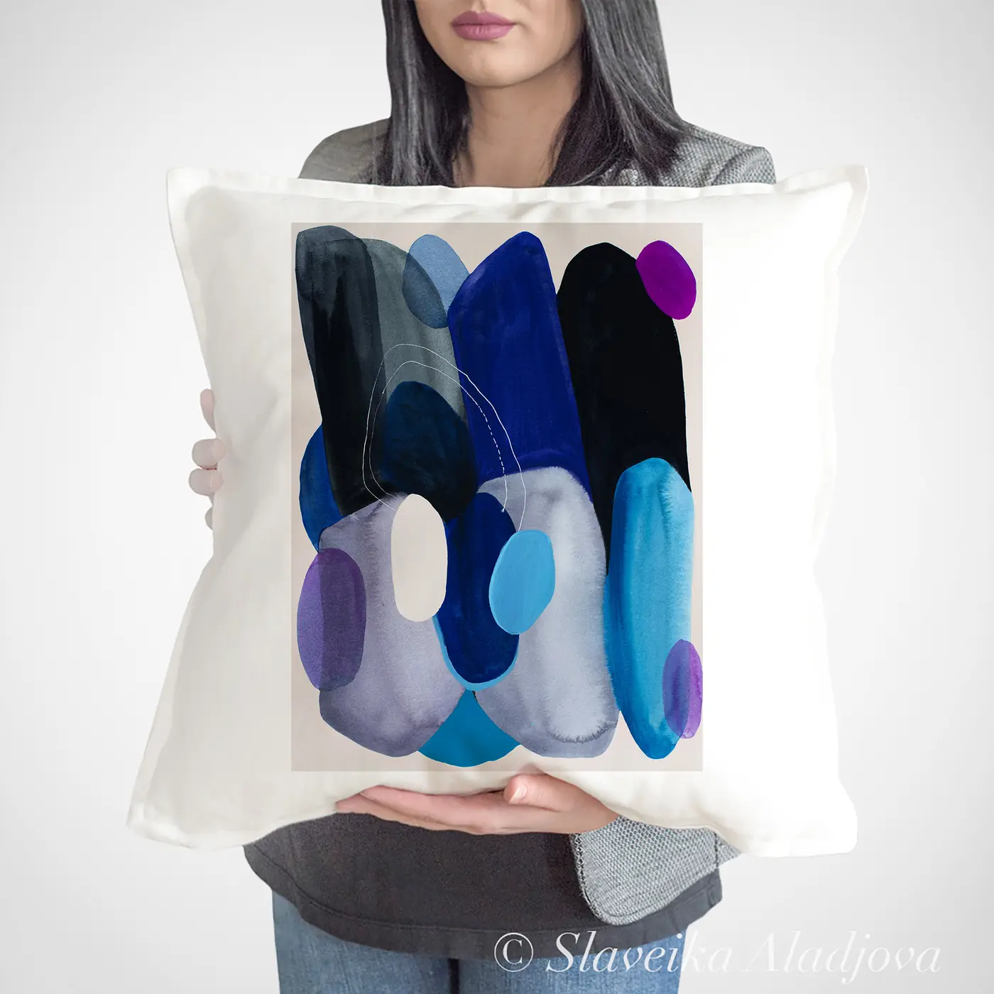 Cushion with a watercolour abstract in blue and grey print