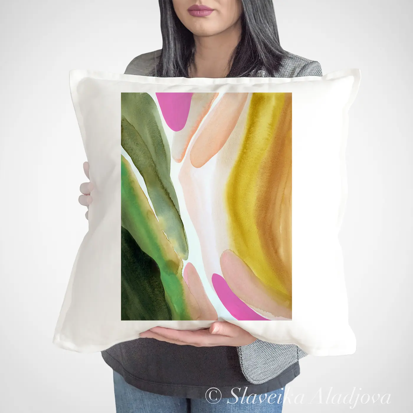 Cushion with a watercolour abstract in green and pink print