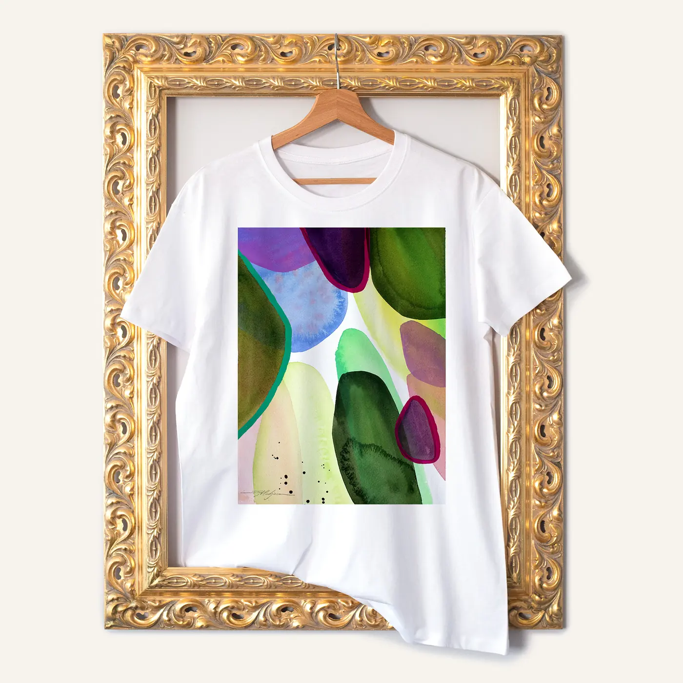 White t-shirt with a watercolour abstract in green and purple print