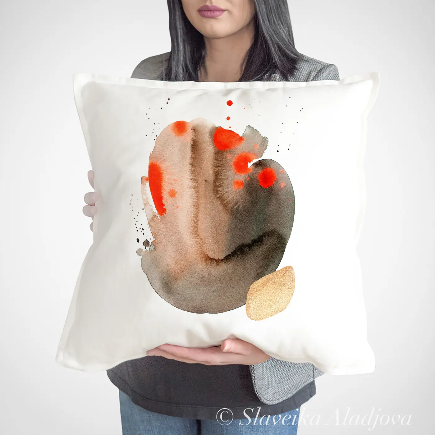 Cushion with a watercolour abstract in sand and orange print