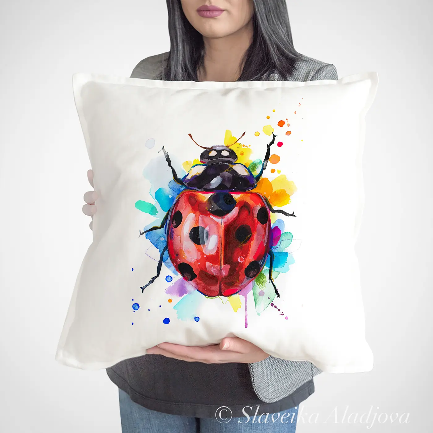 Cushion with a watercolour ladybird print